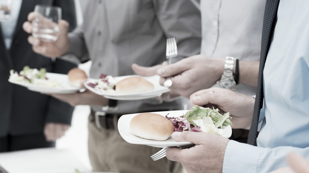People eating food while standing