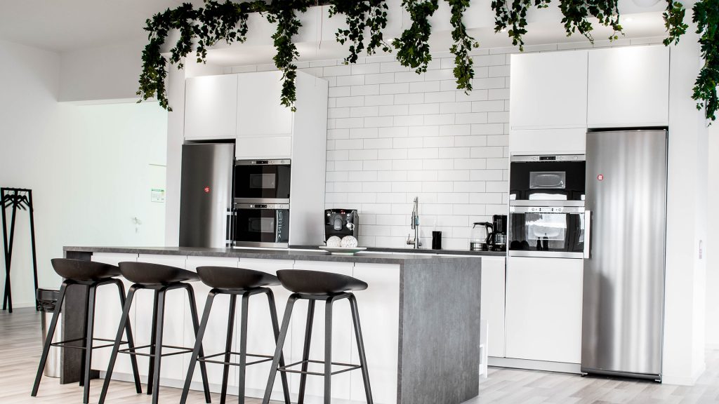 A kitchen with a kitchen island and several bar stools