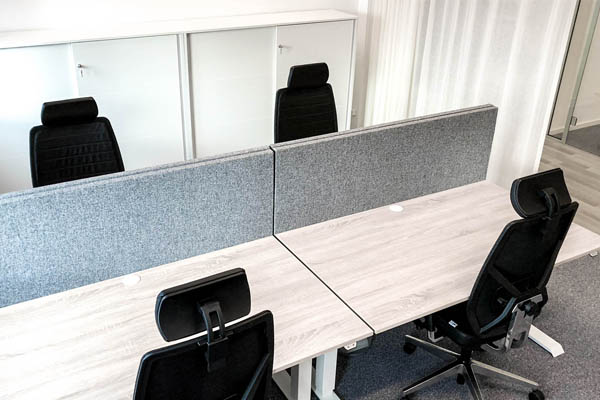A office room with tables, chairs and storage cabinets