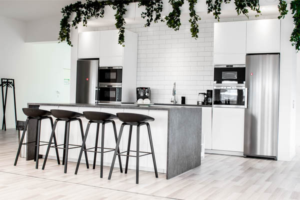 A kitchen with a kitchen island with some bar stools