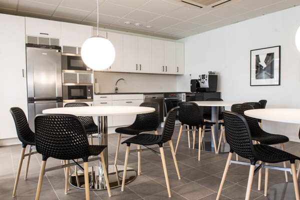 A lunch room with tables and chairs
