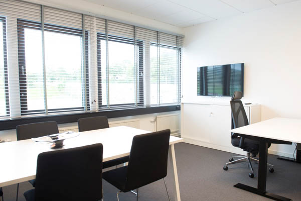 A office room with chairs and tables
