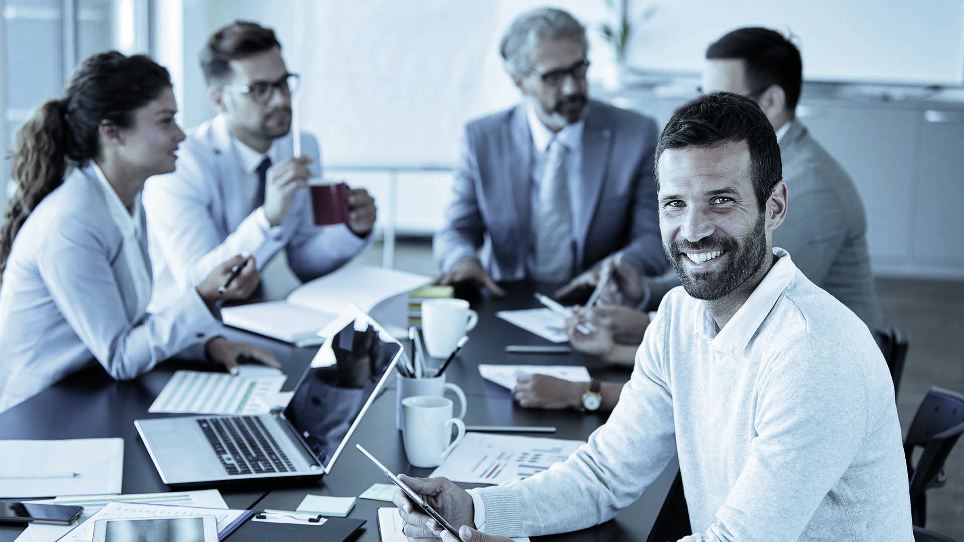 People in a meeting smiling